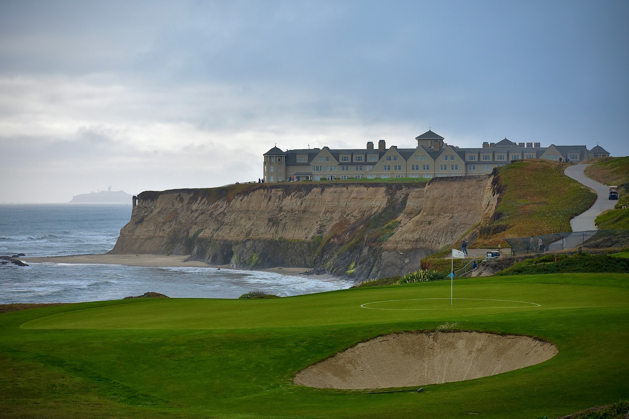 A golf hole with an ocean and cliff backdrop at Half Moon Bay Golf Links, California